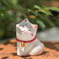 Adorable figurine of cat with their cheeks pressed together