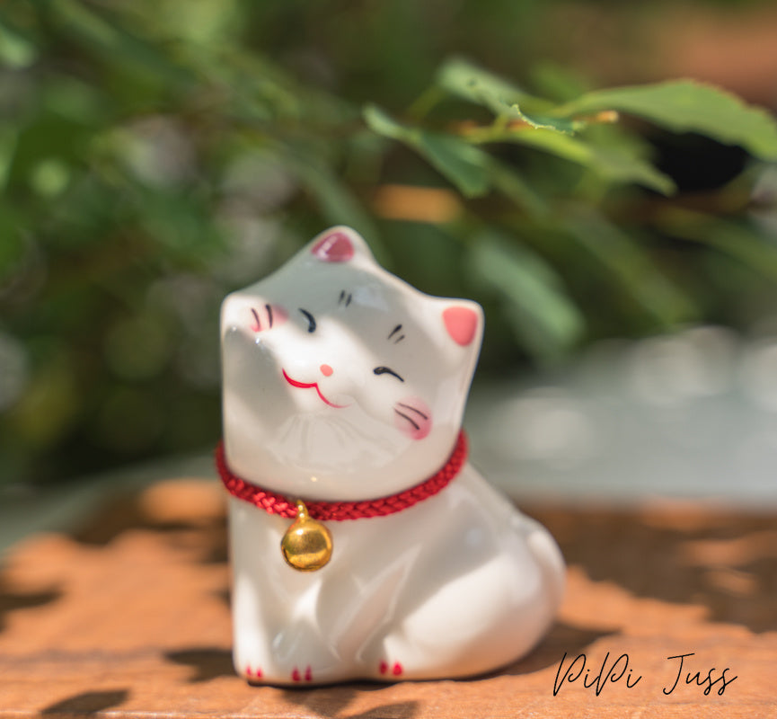 Adorable figurine of cat with their cheeks pressed together