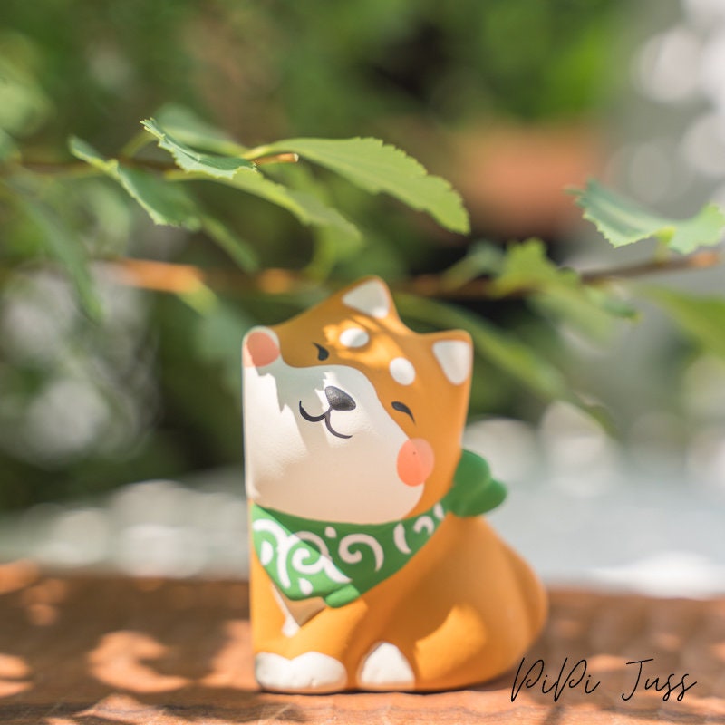 Cute Figurine Of Shibu Inu Pressing Cheeks Together