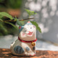 Adorable figurine of cat with their cheeks pressed together