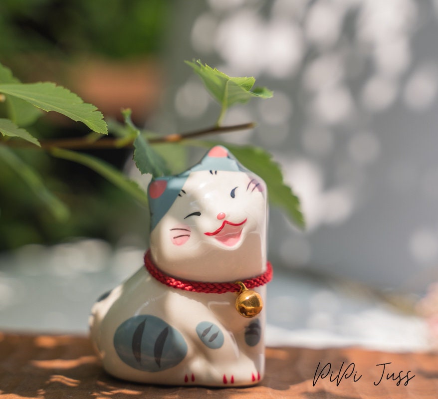 Adorable figurine of cat with their cheeks pressed together