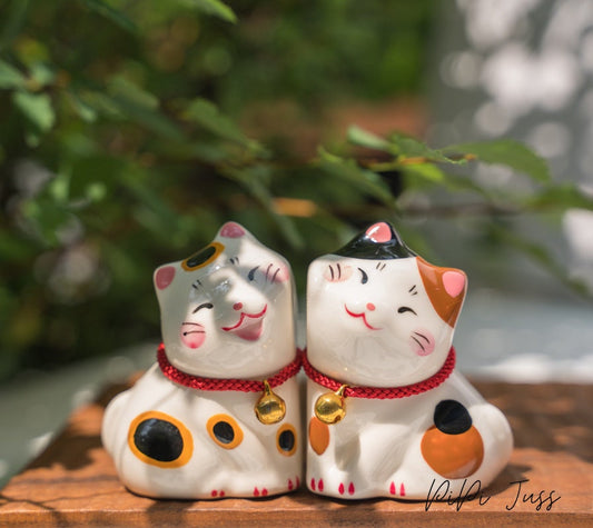 Adorable figurine of cat with their cheeks pressed together