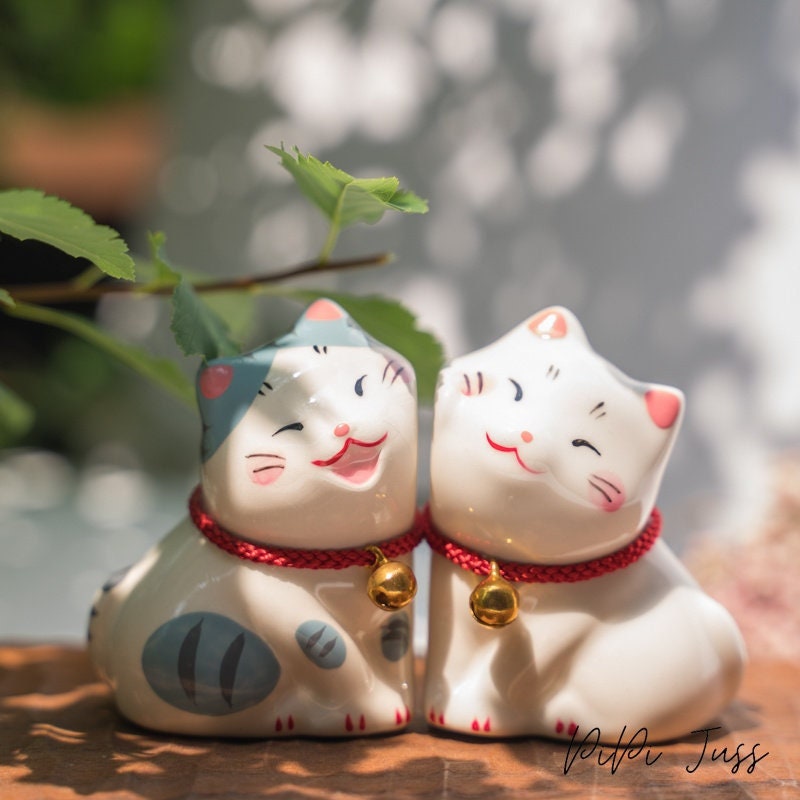 Adorable figurine of cat with their cheeks pressed together